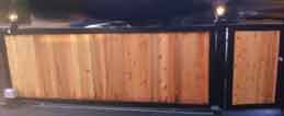 Wooden gate with black metal frame